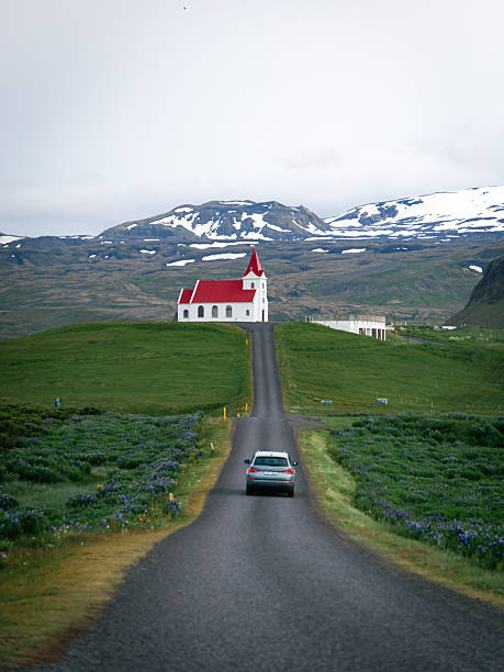 Hellissandur, Iceland - June 26, 2025: A car drove towards the Ingjaldsholl church.