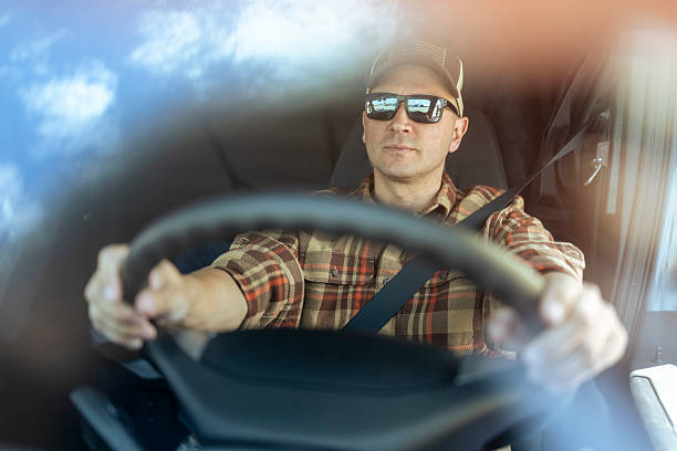 istock Daytime drive – professional truck driver with eyeglasses at work 2228189084