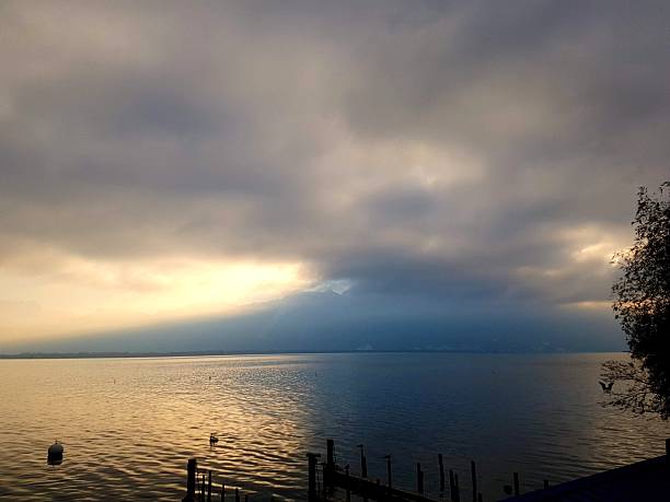 istock Unique winter evening atmosphere on Lake Geneva with sunset colors and dramatic clouds reflected on the calm lake 2228191665