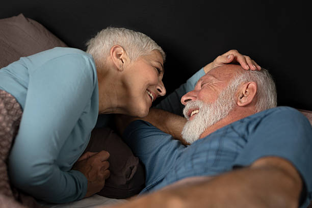 istock Senior couple enjoying a peaceful moment in bed, they both smile. 2228193123