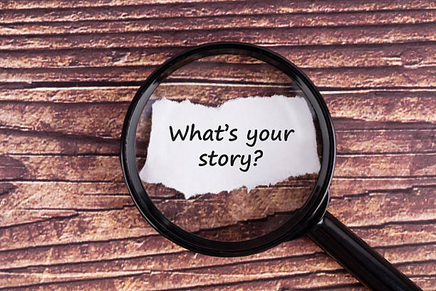 istock Magnifying glass focused on torn paper with text what's your story? 2228193575