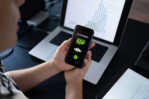 istock Woman using AI Chatbot on her smart phone while working in the office 2228194986