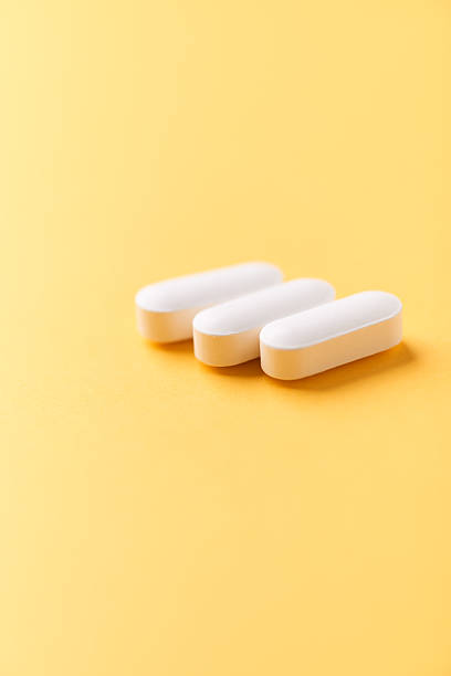 istock Magnesium tablets on bright paper background. Soft focus. Close up. Copy space 2228195041