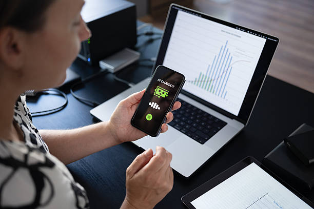 istock Woman using AI Chatbot on her smart phone while working in the office 2228195187