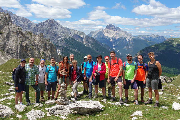 A group of friends took a photo as a souvenir of their excursion to the Dolomites near Cortina d'Ampezzo, \nItaly, 2025