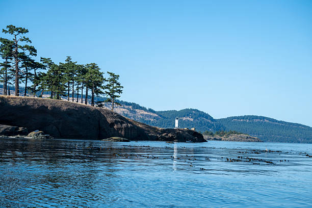 Calm bay and distant lighthouse, Pender Island, Gulf Islands, B.C.