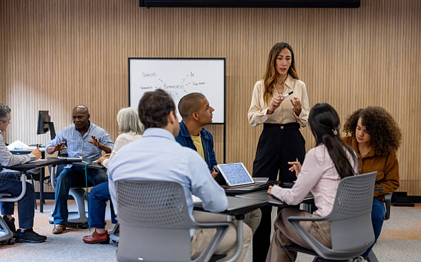 istock Teacher talking to a group of students having a debate in class 2228200306