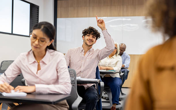 istock University student raising his hand to ask a question in class 2228200307