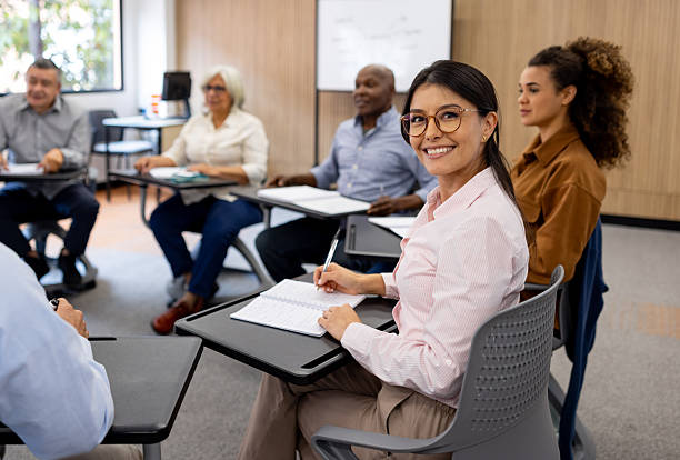 istock Happy female student having a debate in class with her classmates 2228200326