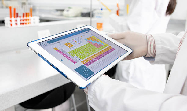 istock Scientist looking at a periodic table on a tablet at the laboratory 2228200341
