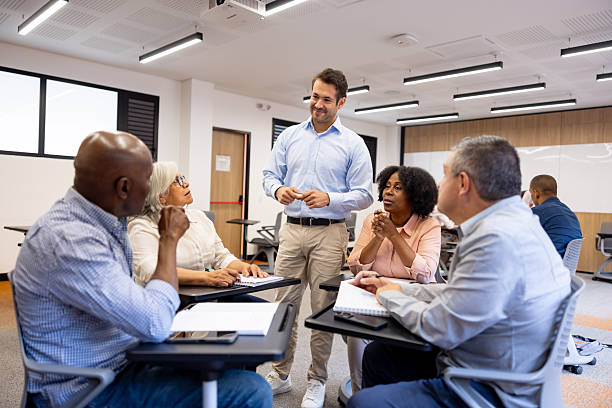 istock Teacher talking to a group of senior students having a debate in class 2228200382