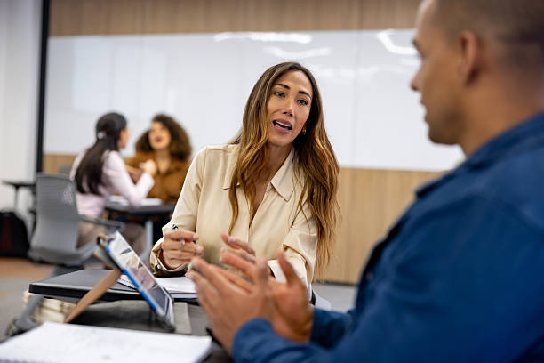 istock Female student talking to a classmate in a debate in class 2228200383