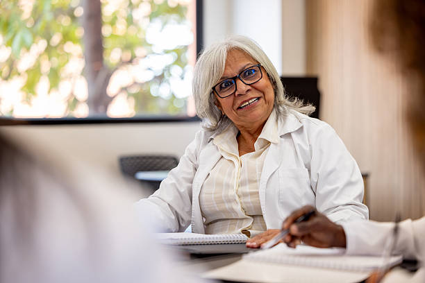 istock Doctor in a seminar listening to a colleague while having a debate 2228200413