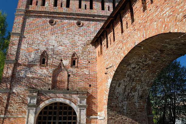 istock Historic brick architecture with an arch in a vibrant green park setting during a sunny day 2228203634