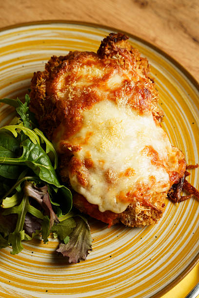 istock Crispy chicken parmigiana with salad 2228203681