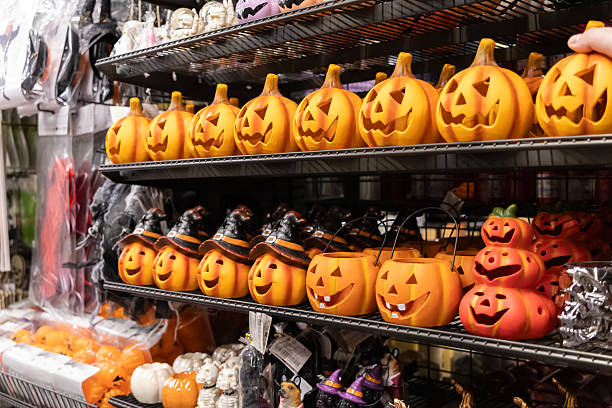 istock Retail display shelves packed with vibrant Halloween pumpkin decorations, featuring classic jack-o'-lanterns and witch-hat pumpkins, perfect for festive shopping 2228204848