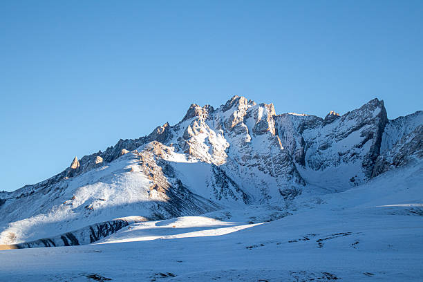istock Snow-covered mountain peaks under a bright clear sky 2228205575