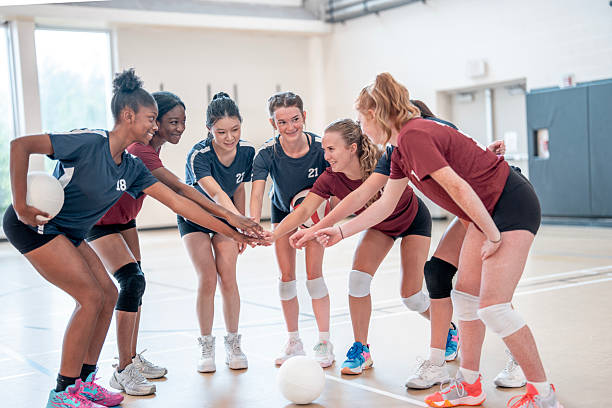 istock Young Female Volleyball Team Celebrating with Hands Together in Unity 2228205784