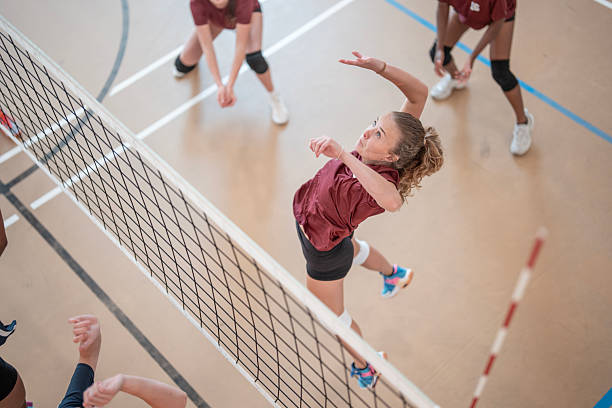 istock Female Athlete Preparing to Spike Volleyball During Intense Game 2228205976