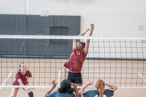 istock Dynamic Volleyball Game Showcasing Players Spiking and Blocking at the Net 2228206018