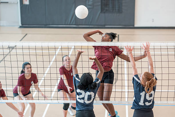 Women's Volleyball Game in Action Inside an Indoor Sports Facility stock photo