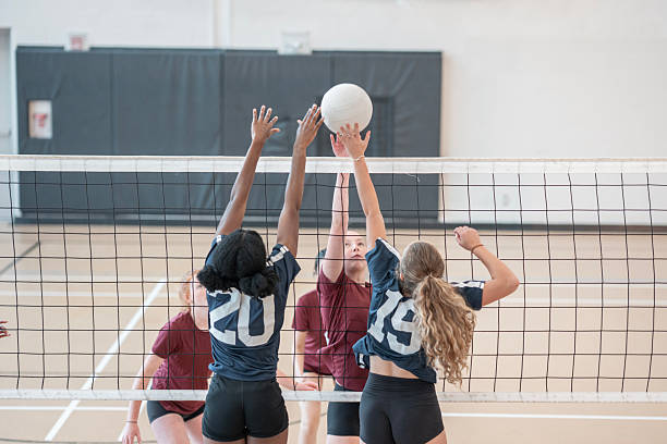 istock Energetic Volleyball Match Between Two Teams in a School Gymnasium 2228206183