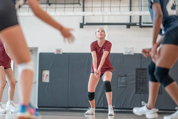 istock Female Volleyball Player Preparing to Defend During Game Indoors 2228206262
