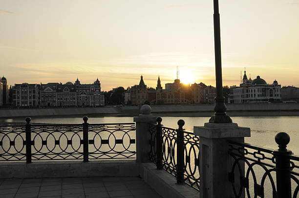 city embankment in summer at sunset