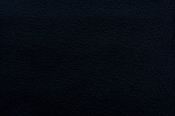 Black macro synthetic leather surface,Natural, genuine black leather texture close up, macro. Structure of glossy leatherette, artifical skin surface with embossing pattern. Background,