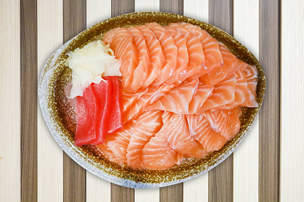Top view of Salmon Fresh Sasimi and fresh tuna with ice in a bowl, focus selective