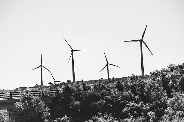 Wind power stations in the mountains. Black and white photo.