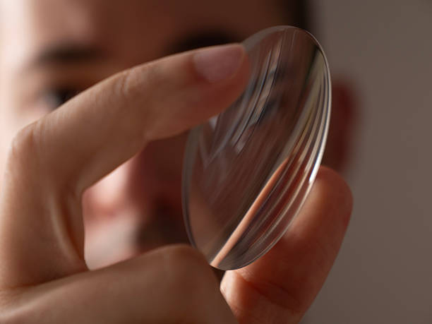 istock professional optometrist doctor man holding and looking a glass lens inside laboratory 2228213507
