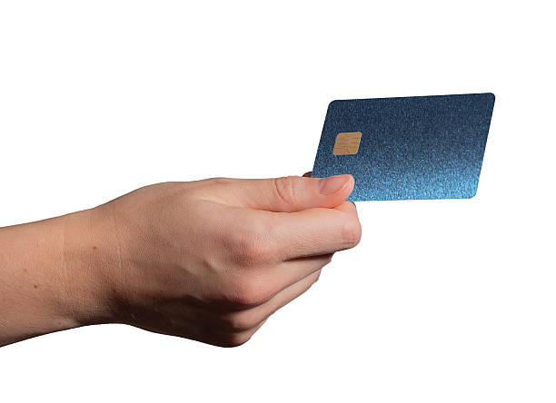 istock Bank card held in hand, showcasing a shiny blue plastic design with a chip. Customer using the card 2228213901