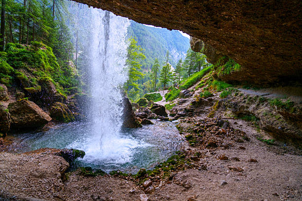 Back side view, from cave, of waterfall Upper Pericnik, which falls from the cascade in Triglav National Part, Slovenia.