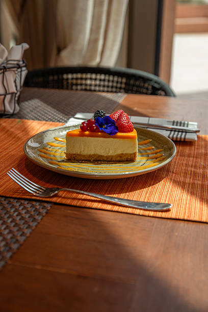 Mango cheesecake with fruit and berry topping served for dessert in restaurant