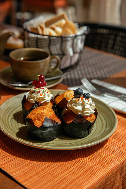 Breakfast table with sweet pastry cupcakes muffins  glazed with sugar icing
