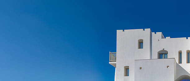 istock Traditional Greek Island Architecture with White Cubic Buildings Against Deep Blue Sky 2228224721