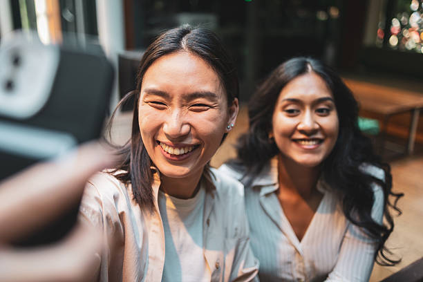 istock Two young women taking a selfie and having fun 2228229398