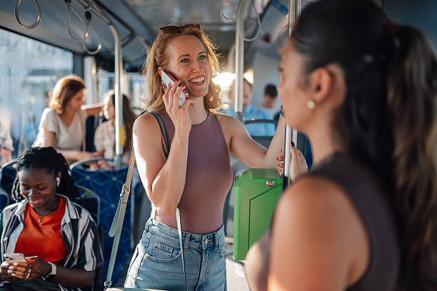 istock Young woman talking on smartphone while riding bus 2228233751