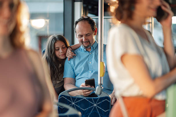 istock Father and daughter sharing a moment on the bus while using a smartphone 2228233815