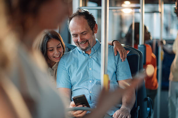 istock Father and daughter enjoying smartphone on bus ride 2228233822