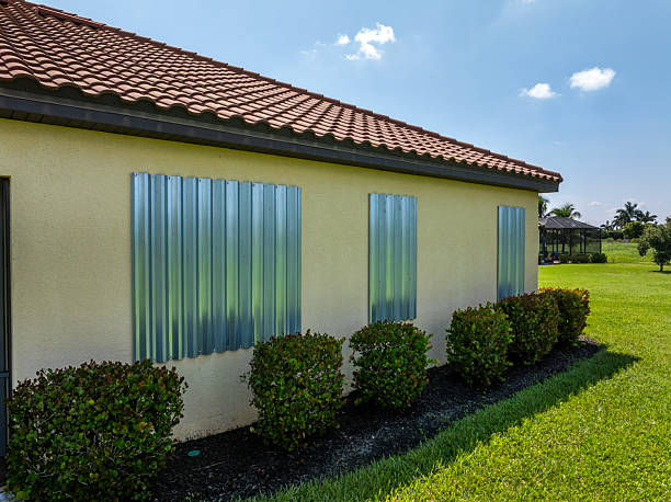Hurricane shutters on Florida house windows. Home protection before natural disaster.