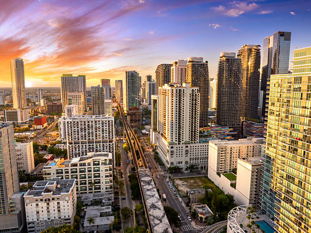 istock Elevated train system through Brickell district in Miami, Florida with city skyscrapers and sunset skies highlighting the public transportation network 2228234880