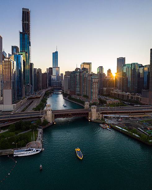 istock Chicago River Skyline with Yellow Tour Boat at Sunset 2228235179