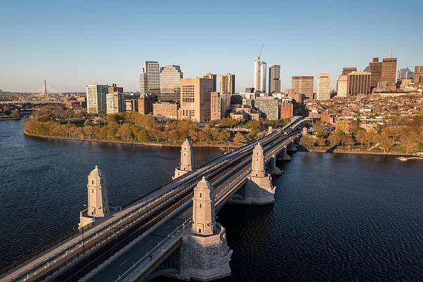 Drone view over Longfellow Bridge with the Boston skyline at golden hour.