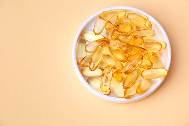 istock Golden Capsules in White Bowl 2228235714