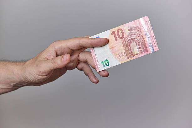 istock Hand Holding Euro Banknotes on Neutral Background 2228238266