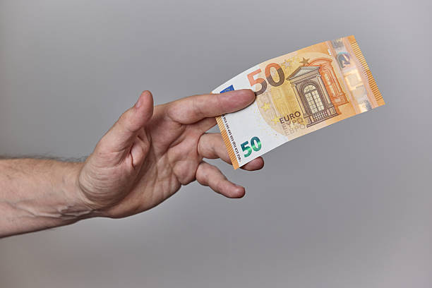 istock Hand Holding Euro Banknotes on Neutral Background 2228238275