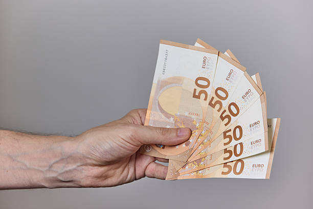 istock Hand Holding Euro Banknotes on Neutral Background 2228238601