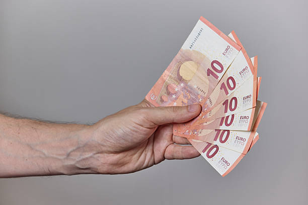 istock Hand Holding Euro Banknotes on Neutral Background 2228238631